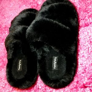 Black furry slippers